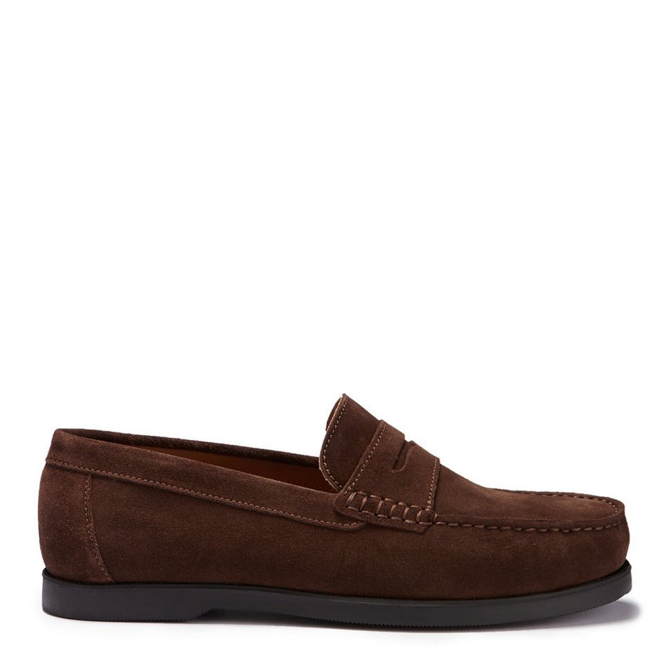 A brown suede boat loafer with a rubber studded sole.